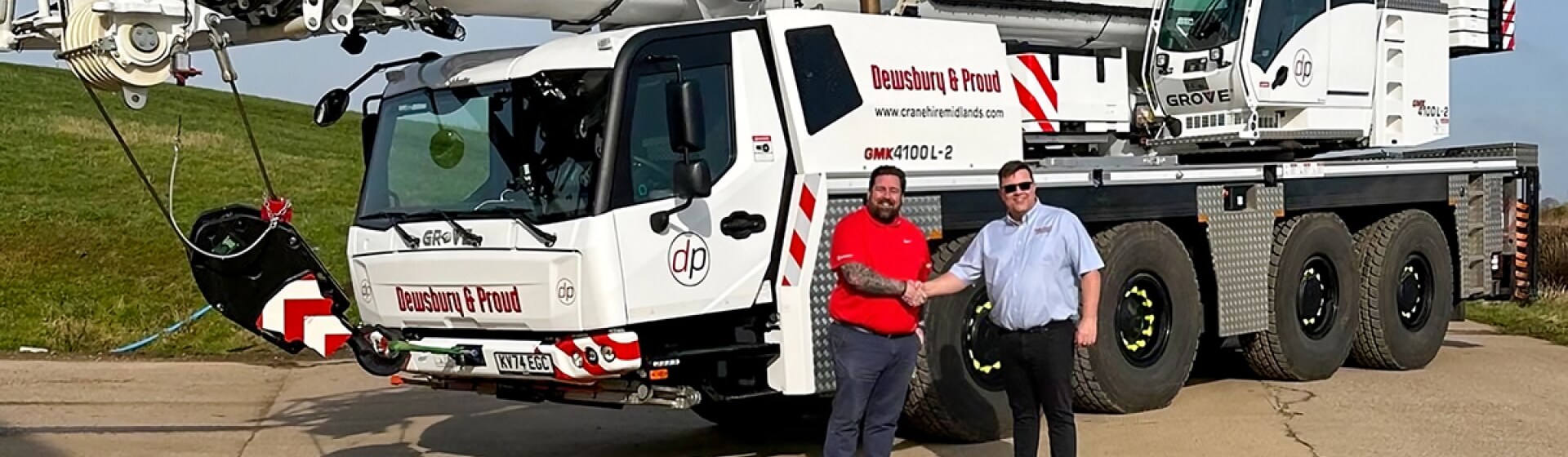 Jim Leishman of Manitowoc, with Tim Proud of Dewsbury & Proud, celebrating the delivery of the company’s latest Grove GMK4100L-2 cranes. Busy-start-for-two-new-Grove-GMK4100L-2-cranes-at-UK-rental-company-01.jpg